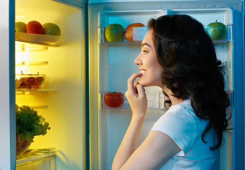 Girl looks at refrigerator during fast weight loss