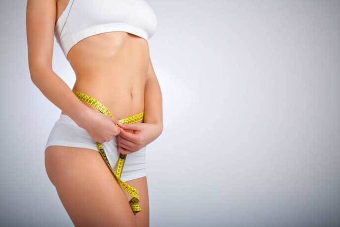 Slim girl measuring waist curls